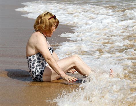 Kellie Maloney Splashes In The Sea In Her Swimsuit On A Beach In