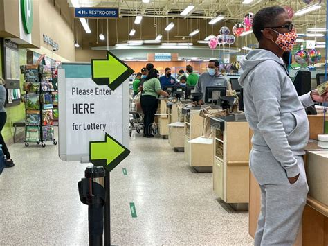 People Waiting In Line To Purchase Lottery Tickets At A Publix Grocery