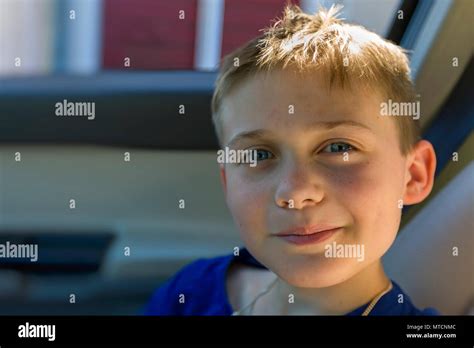 Close Up View Portrait Of Cute Young 10 Year Old Caucasian Boy In Car