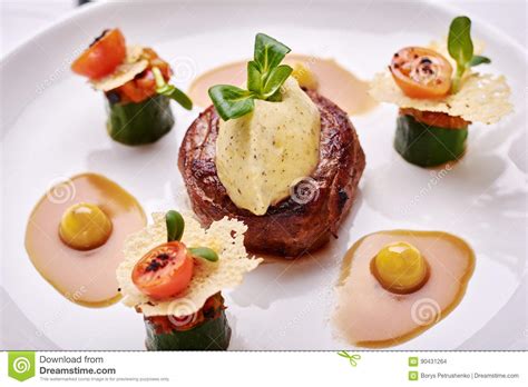 Beef Filet Dinner Entree With Garnish And Brown Sauce Displayed On A