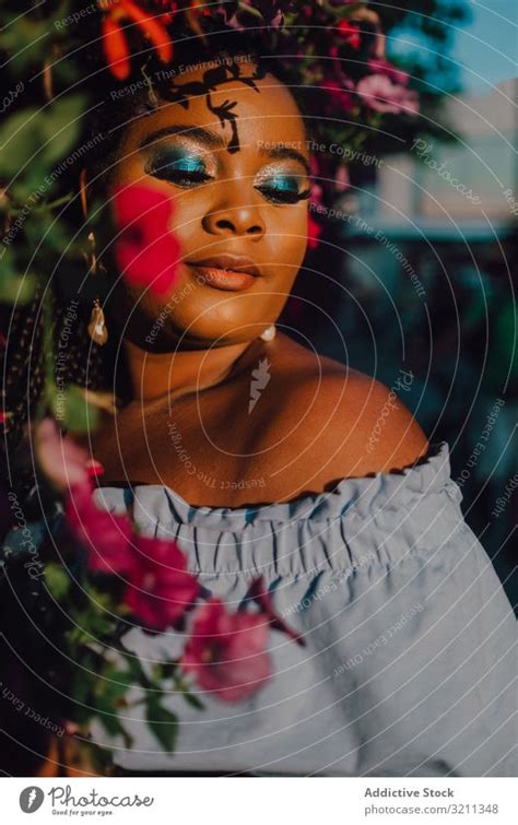 Joyful Trendy African American Woman Standing Beside Blossomed Tree A