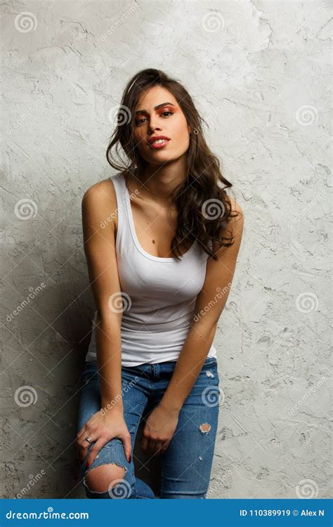 Photo Of Beautiful Brunette In White Tank Top And Ripped Jeans Stock Image Image Of Glamour