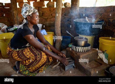 Zambia Sinazongwe Village Mweezya Woman Cooks With Energy Saving