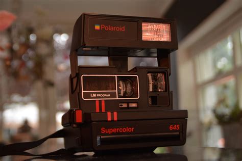 Black Polaroid Supercolor Camera On Black Table · Free Stock Photo