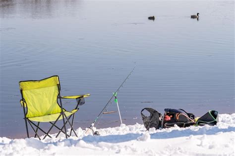Premium Photo Two Chairs On The Snow With A Fishing Rod And A Bag Of