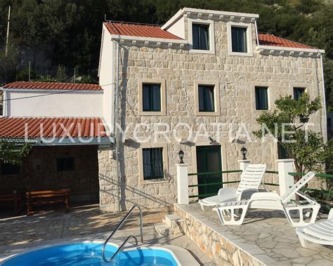 A harge stone house with whit spots and a window. Large stone house with pool and a view Peljesac Luxury ...