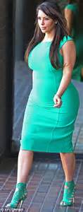 kim kardashian cuts a sombre figure as she steps out tight green dress while kanye west
