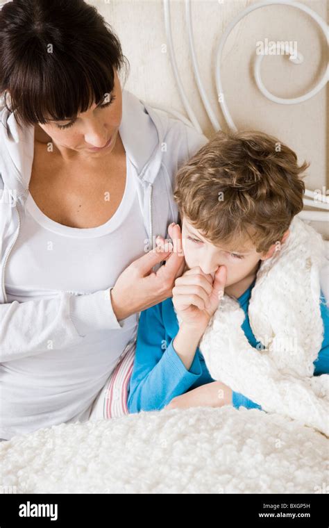 Mother Taking Care Of Sick Son Stock Photo Alamy
