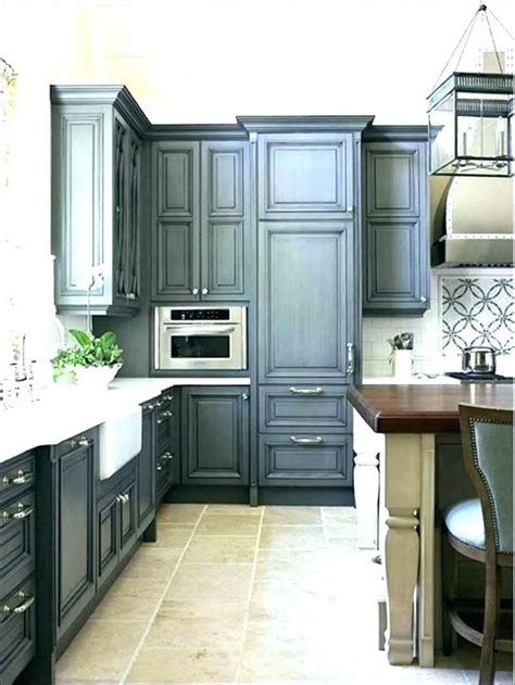 Another unique element of this kitchen would be its kitchen island, which almost looks like a massive dining table with a cabinet base. Navy Blue Kitchen Cabinets Distressed Dark | Dark grey ...