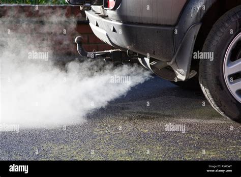 Exhaust Cloud From A Car Engine Revving Uk Pollution And Fumes Stock
