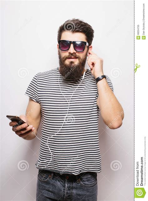 Happy Hipster With Beard Wearing Shirt And Sunglasses Enjoying Music