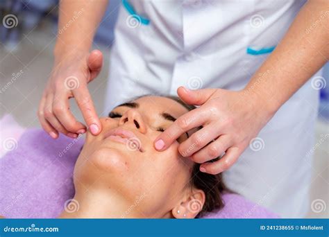 Relaxing Massage European Woman Getting Facial Massage In Spa Salon Side View Stock Image