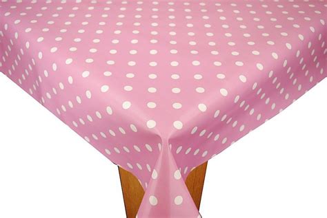 a pink table cloth with white polka dots