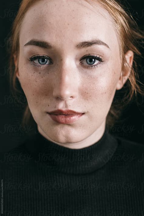 Closeup Portrait Of A Ginger Freckled Woman On Black By Stocksy