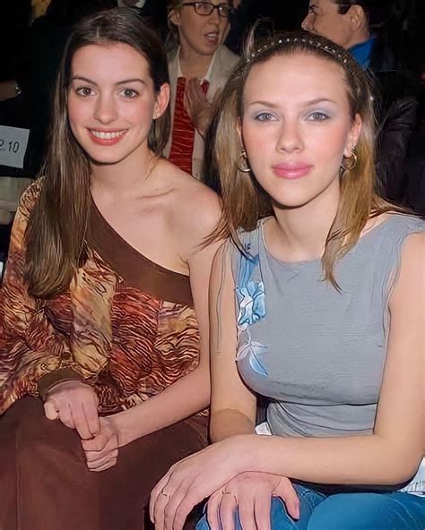 Two Women Sitting Next To Each Other At A Fashion Show
