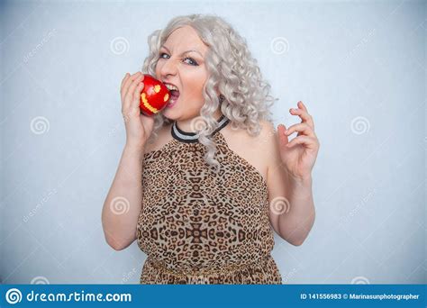 Chubby Blonde Girl Wearing Summer Dress And Posing With Big Red Apple On White Background Alone