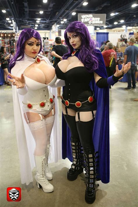 Two Women Dressed In Cosplay Costumes Posing For The Camera At A Convention Center