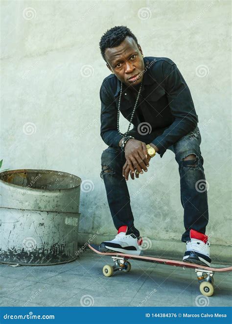 Young Attractive And Serious Black African American Man Squatting On