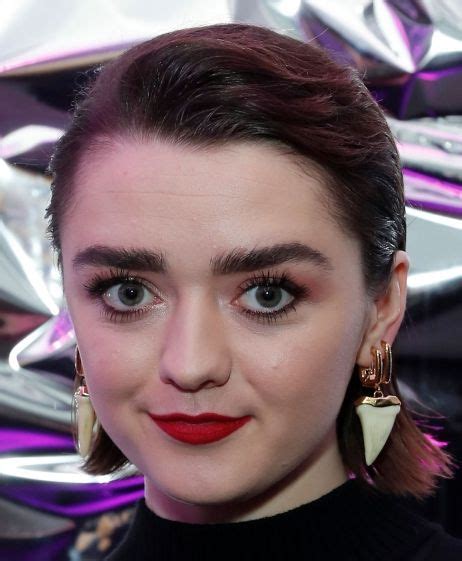 Close Up Portrait Of Maisie Williams With Red Lipstick And Large Earrings