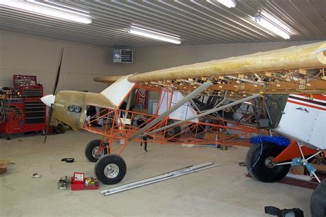 An Airplane Is Being Worked On In A Garage With Other Tools And