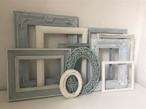 Shabby chic style display of open photo frames painted in white and ...