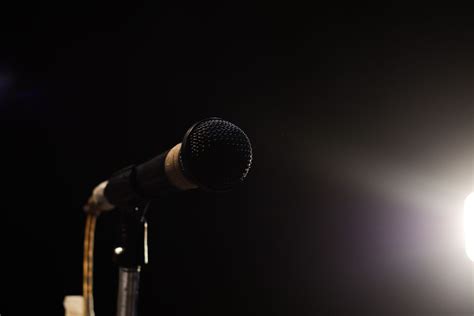 singing mic on a black background with space for text - TBWA