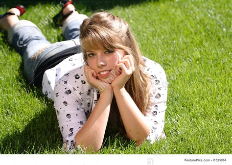 David prado / addictive creative; Teenage Girl Laying In The Grass Image
