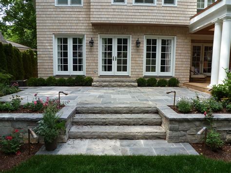 A House With Stone Steps Leading Up To The Front Door