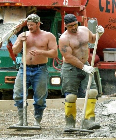 Two Men With Shovels And Work Boots Are Standing In Front Of A