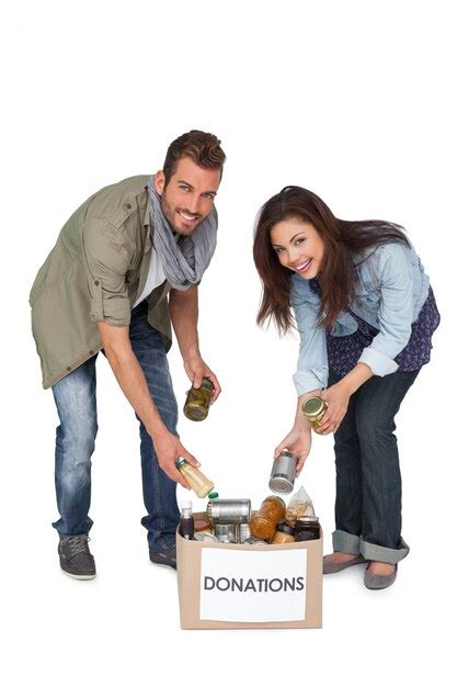 Premium Photo Portrait Of A Smiling Young Couple With Donation Box