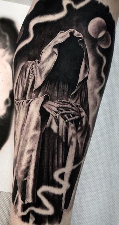 A Mans Arm With A Black And White Tattoo On It Depicting The Statue