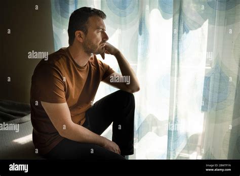 Thoughtful Anxious Guy Portrait Looking Out The Window Stock Photo Alamy