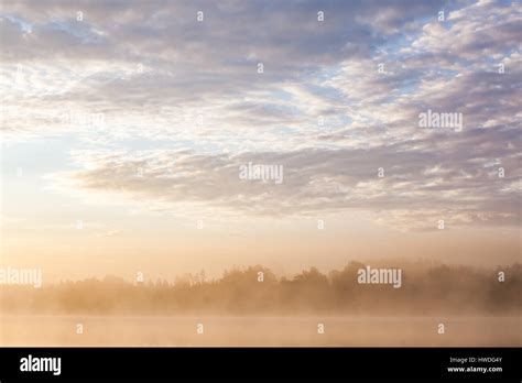Sunrise At Foggy Lake Stock Photo Alamy