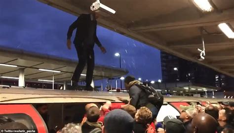 Furious Commuters Drag Extinction Rebellion Protesters From The Roof Of A Dlr Train Daily Mail
