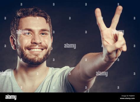 Portrait Of Happy Smiling Handsome Man Guy Giving Peace Victory V Sign