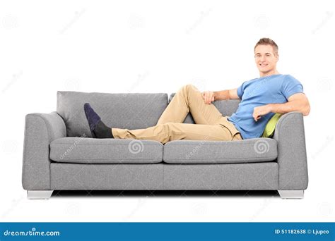 Relaxed Young Man Sitting On A Comfortable Sofa Stock Photo Image Of