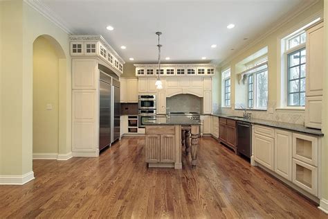 The warm cabinets in this kitchen supplement the wood flooring, while at the same time everything is adjusted by the black countertops and stainless steel appliances. 43 "New and Spacious" Light Wood Custom Kitchen Designs