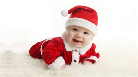 Baby Wearing Santa Claus Dress While Taking Photo Lying On White Mat Hd