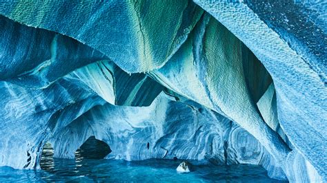 The marble caves in chile are a true natural wonder, full of vibrant splashes of color thanks to the sparkling turquoise water. Hot Shots: The Marble Caves, Patagonia, Chile | Escapism TO