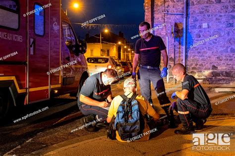 Drunk Person Lying On The Pavement Firefighters From The Emergency Rescue Services In Roanne