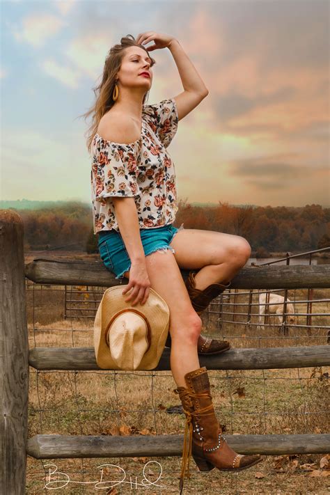 Country Girl Watching The Sunset On The Farm During A Fall Photoshoot