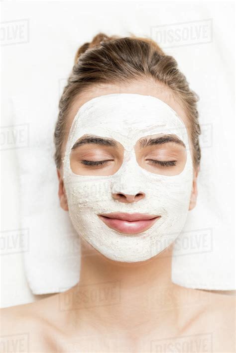 Spa Therapy For Woman With Closed Eyes Receiving Facial Mask Stock