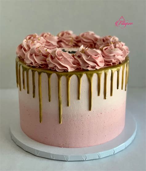 single tier pink buttercream cake with gold drip and pink buttercream rosettes green birthday