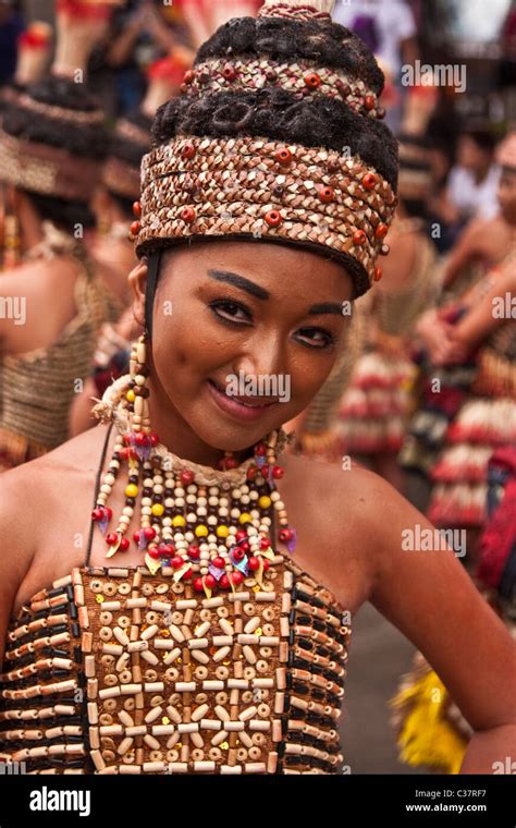 A Portrait Filipina Street Dancer In Full Brown Costume With Head Gear