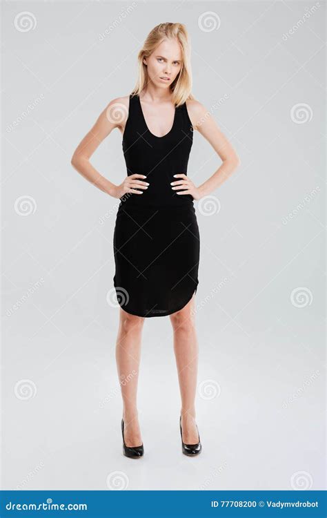 Beautiful Woman Posing In Black Dress With Hands On Hips Stock Photo