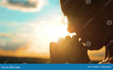 Girl Praying Girl Folded Her Hands In Prayer Silhouette At Sunset