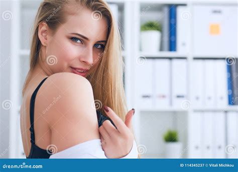 undressed secretary beckons with a finger in office background office provocation stock image