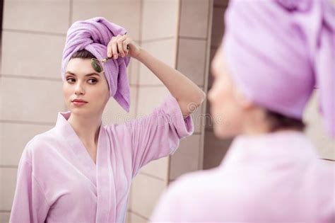 Photo Of Pretty Adorable Young Woman Nightwear Pink Bathrobe Looking Mirror Doing Face Massage