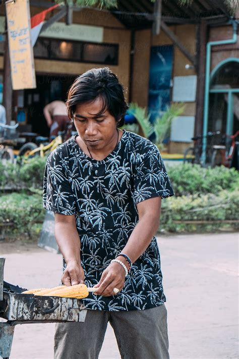 Indonesian Young Man Cooking And Selling Corn On The Street By