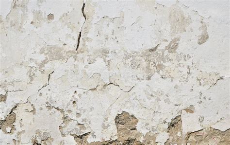Old White Painted Plaster Wall With Cracks And Stains Stock Photo